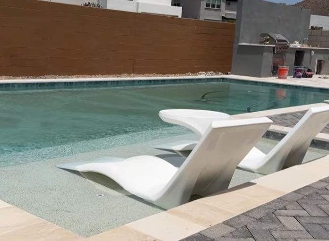Travertine pool deck pavers in a French pattern staying cool underfoot in an Arizona backyard