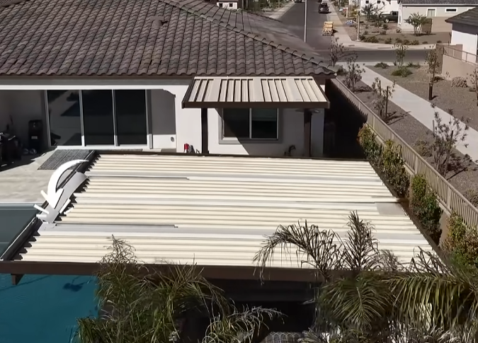 Rain wall water feature built into the edge of a pergola pouring a sheet of water beside an Arizona pool