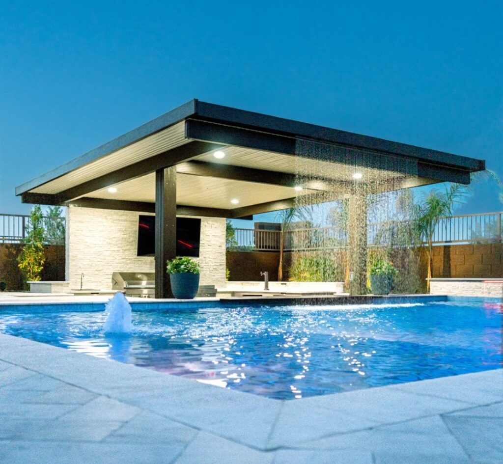 Arizona backyard pool with a shallow sun shelf entry and desert landscaping